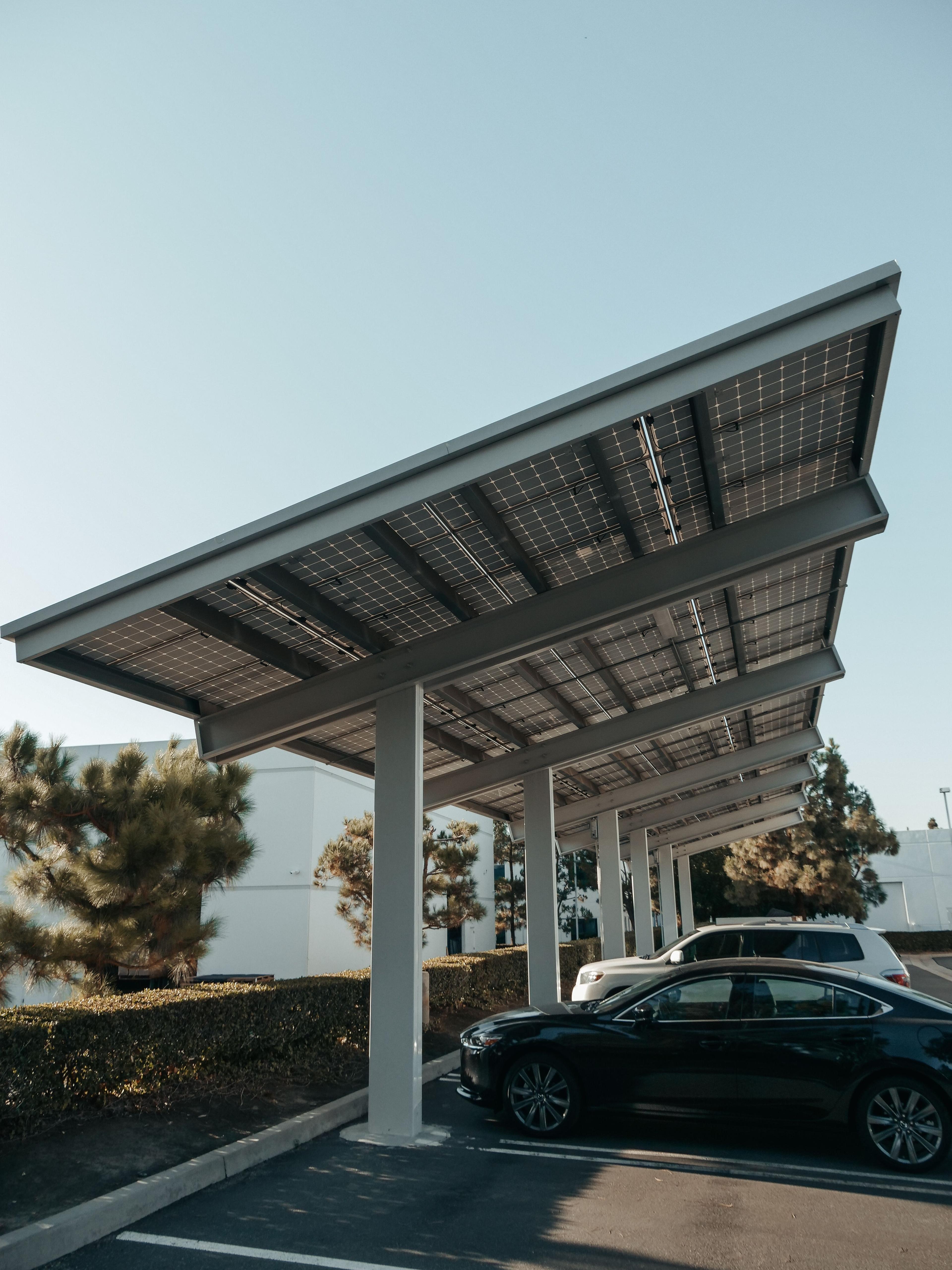 Cars sheltered beneath a solar-panel carport
